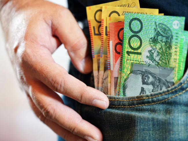 Australian cash money in mans jeans pocket, close up.