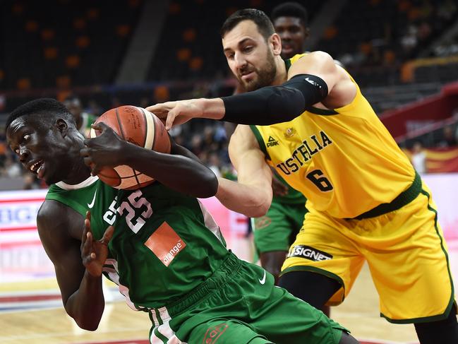 Andrew Bogut fights for the ball with Senegal's Momar Ndoye (L). Picture: Ye Aung Thu/AFP