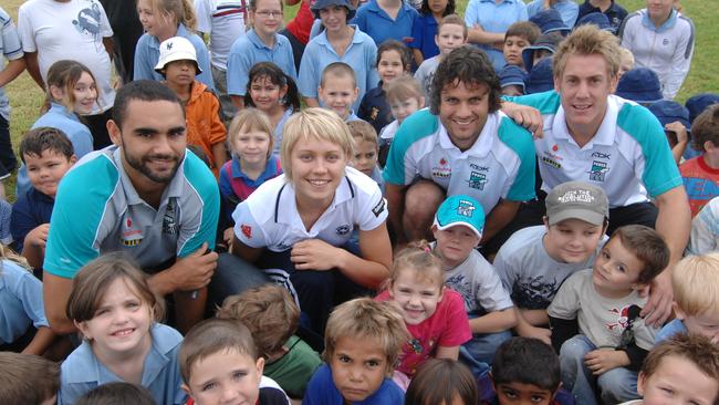 Shaun Burgoyne with basketballer Erin Phillips, Gavin Wanganeen and Brett Ebert with students at Polly Farmer homework centre in South Australia.