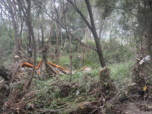 The creek/drain behind Angela Hough and Kay Campbell’s homes was left with a canopy and tyres dumped by the flash flooding.