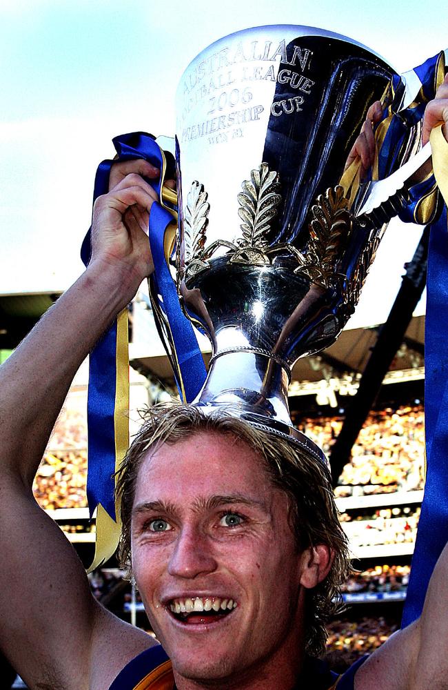 Holding the premiership cup aloft.