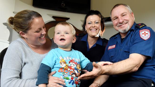 Noah Palonek, 2, with his mum, Rebecca, and paramedics Justyne Kristic and Murray Kennedy. Picture: Kylie Else