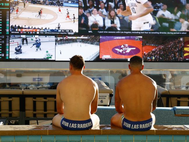 DAILY TELEGRAPH FEBRUARY 21, 2025. Canberra Raiders from left Owen Pattie and Jamal Fogarty with their Viva Las Raiders swimmers on as the players going for a swim at Stadium Swim in Las Vegas. Picture: Jonathan Ng