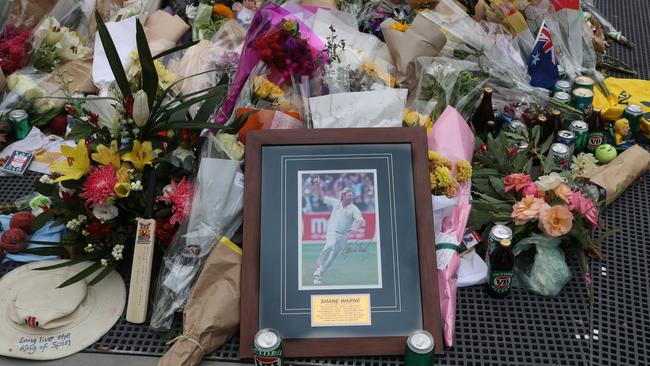 Flowers and other tributes at the statue of Shane Warne at the Melbourne Cricket Ground, where his state funeral will be held. Picture: David Crosling