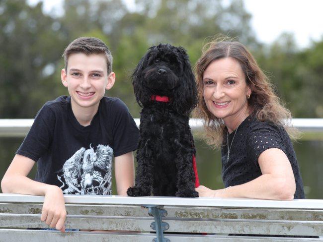 Lynne Stewart and son Alex with their dog Charley have finally been reunited after Lynne had flights home cancelled because of caps on returning citizens. Picture Glenn Hampson