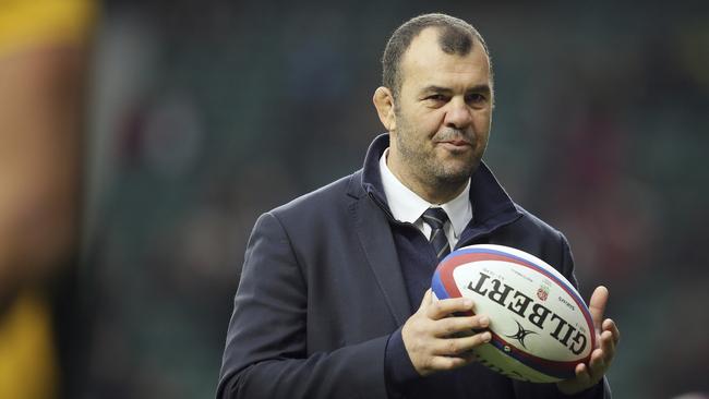 Wallabies coach Michael Cheika watches his players warm-up at Twickenham early  yesterday. Picture: AP