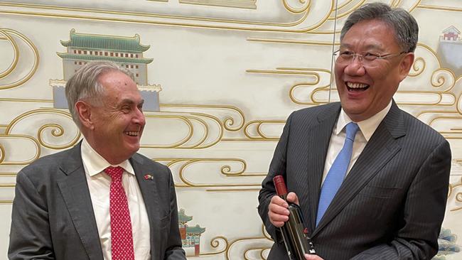 Trade Minister Don Farrell gives Chinese Commerce Minister Wang Wentao a bottle of his ‘Godfather Too’ Shiraz after their high-level talks on Friday night.