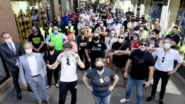 Members of the hospitality sector at the #1in4NoMore protest in Peel Street. They are urging the COVID-19 transition committee to return to one person per two square metres. Picture: NCA NewsWire / Naomi Jellicoe