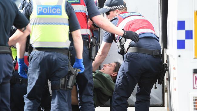 A protester is arrested after outside a house in which squatters had settled.