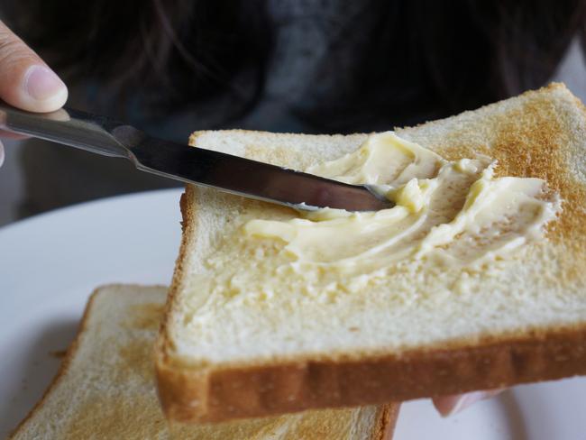 buttering toast with knife