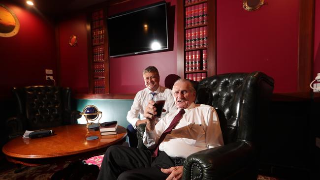 Barrister Chris Garlick watches on as Will Smith toast success in the courts, at his Southport Chambers. Picture: Glenn Hampson.