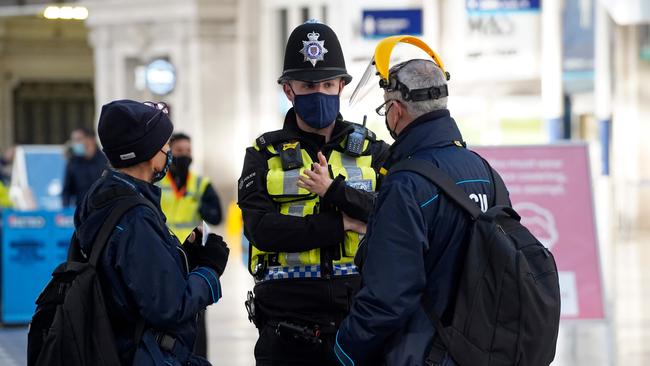 A policeman gives advice at London’s Waterloo Station on Sunday. Picture: AFP