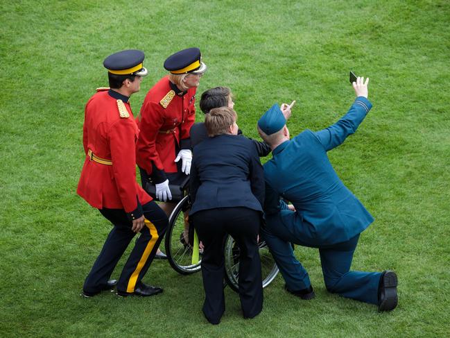 Guests take a picture as they attend a garden party at Buckingham Palace on May 16, 2017 in London, England. Picture: Getty