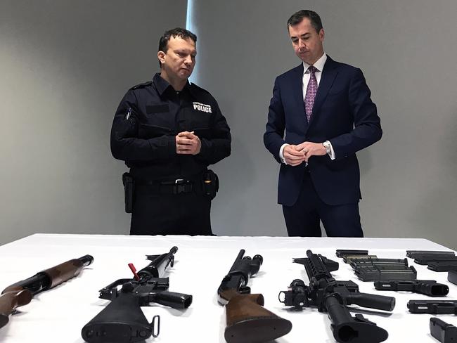 Justice Minister Michael Keenan examines a range of weapons after announcing a new national gun amnesty. Picture: AAP