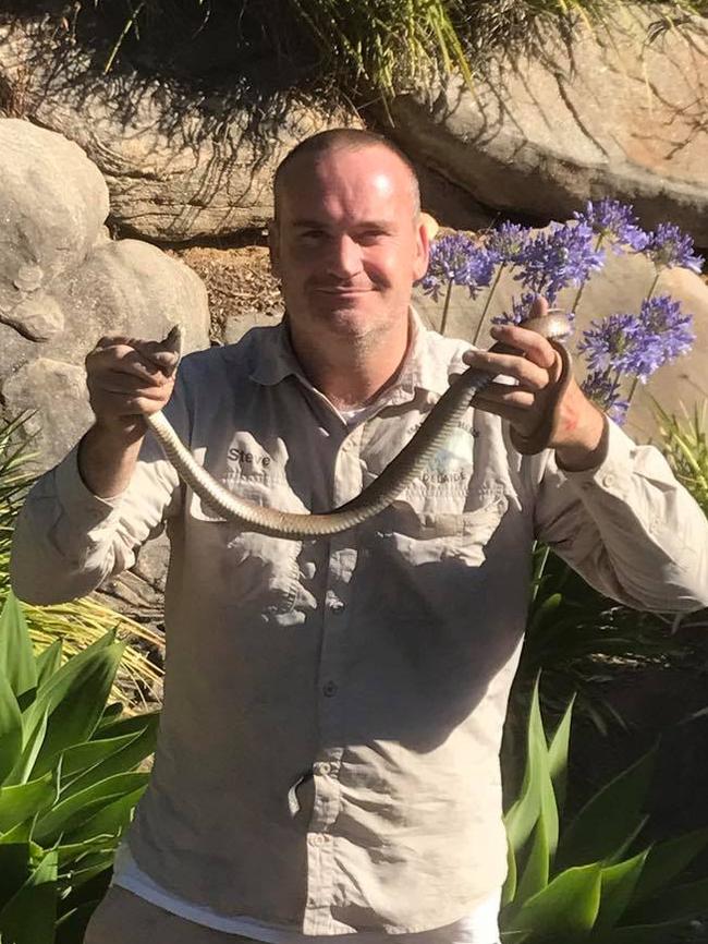 Snake Catchers Adelaide’s Rolly Burrell with a snake found at a Flagstill Hill home. Picture: supplied