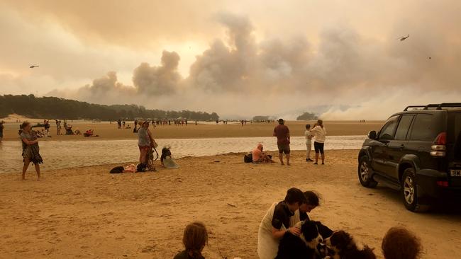 Residents and holiday-makers fled to the beach as fire approached Lake Conjola on NYE. Picture: Supplied