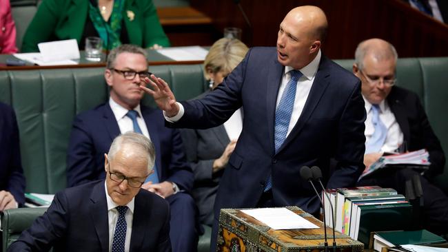 Australia's Minister for Home Affairs Peter Dutton speaking at Parliament as Australian Prime Minister Malcolm Turnbull looks at his notes on August 20. Picture: AFP