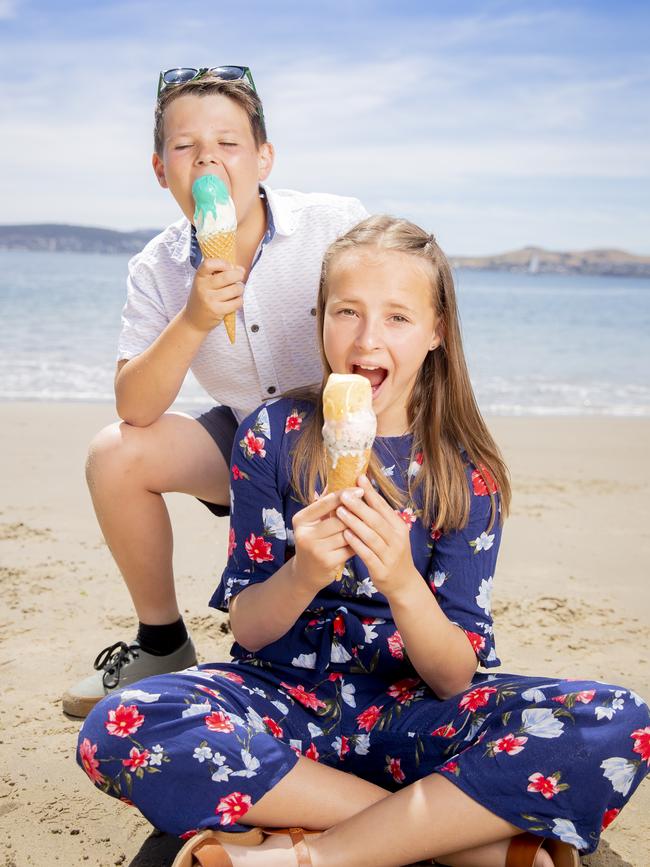 Siblings Hudson Bernes, 10, and Taylah Bernes, 13, enjoy ice creams at Long Beach Sandy Bay. Picture: RICHARD JUPE