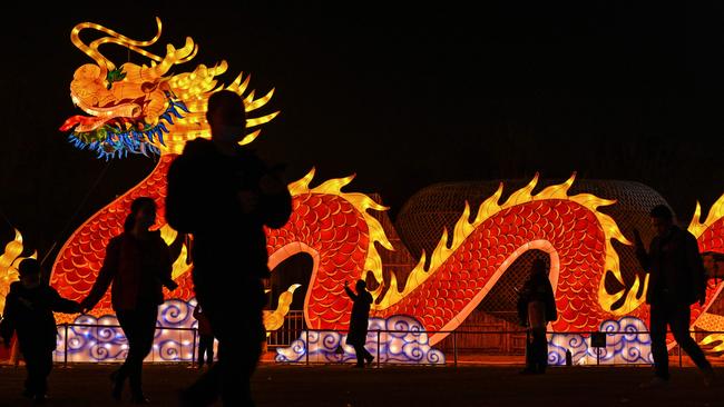 People walk past a giant dragon lantern in a park in Wuhan in China's central Hubei province during the Lunar New Year festival. Picture: AFP