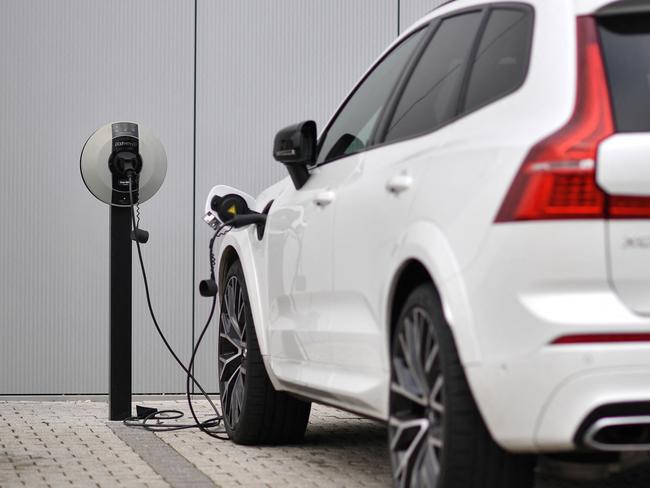 (FILES) In this file photo taken on March 2, 2021 a Volvo XC60 hybrid car is seen plugged into a charging point outside a Volvo dealership in Reading, west of London. - Britain, on June 14, 2022, axed its Â£1,500 ($1,800) subsidy for buyers of new plug-in cars as it focuses on other types of electric vehicles, but the news drew anger from the auto sector. (Photo by Ben STANSALL / AFP)