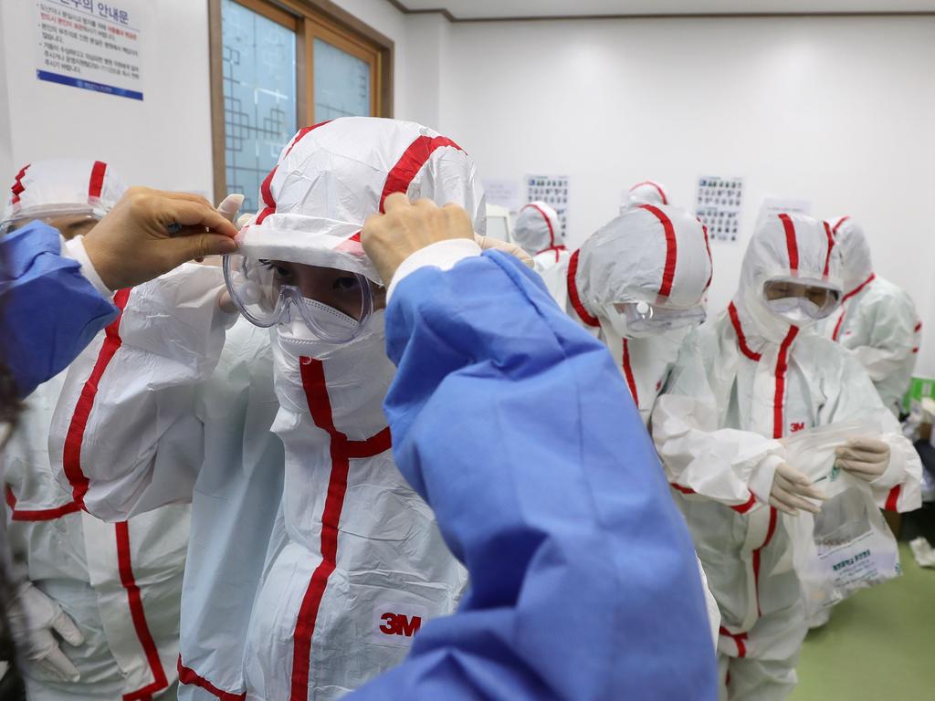 Medical staff members wear protective gear to care patients infected with the COVID-19 coronavirus at a hospital in Daegu, South Korea. Picture: YONHAP/AFP