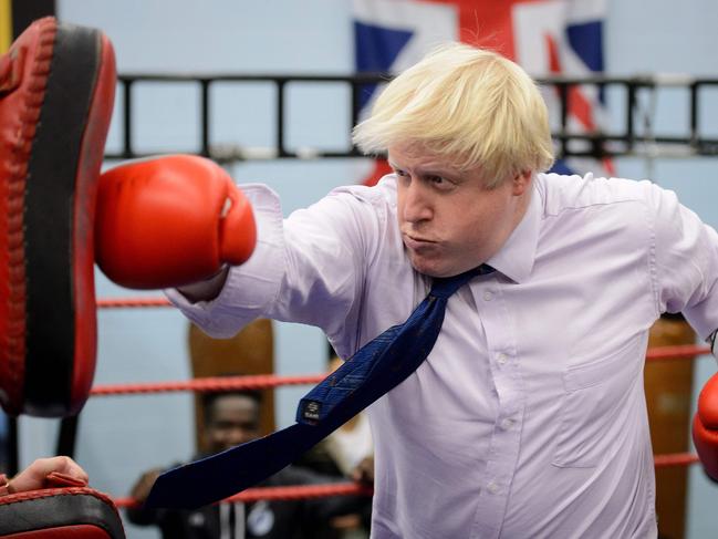 As Mayor of London Boris Johnson boxes with a trainer during his visit to Fight for Peace Academy in North Woolwich, London. Picture: AFP