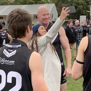 Barry Hall poses for a a selfie with a fan during the quarter-time huddle. Picture: JAMES KITTO