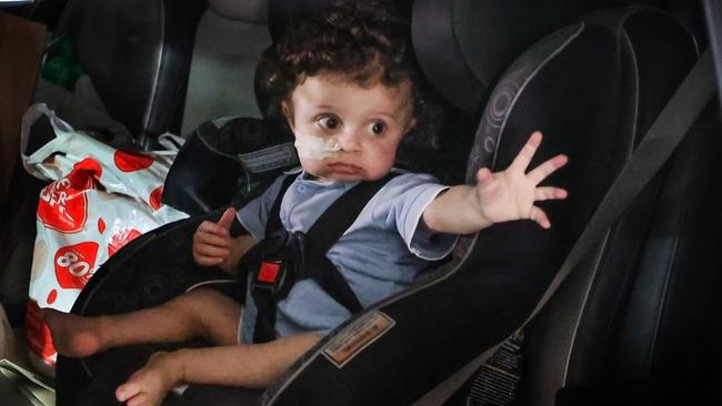 Harlen waves goodbye to hospital staff from the car. Picture: David Caird