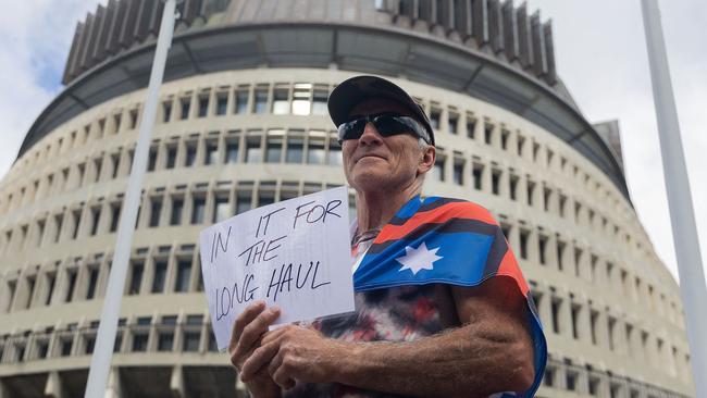 An activist holds a sign that reads ‘In for the long haul’ outside Parliament on the ninth day of demonstrations against Covid-19 restrictions in Wellington. Picture: AFP