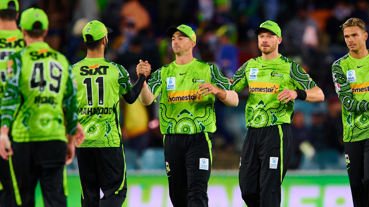 CANBERRA, AUSTRALIA - DECEMBER 28: Thunder players celebrate victory during the Men's Big Bash League match between the Sydney Thunder and the Perth Scorchers at Manuka Oval, on December 28, 2021, in Canberra, Australia. (Photo by Brett Hemmings/Getty Images)