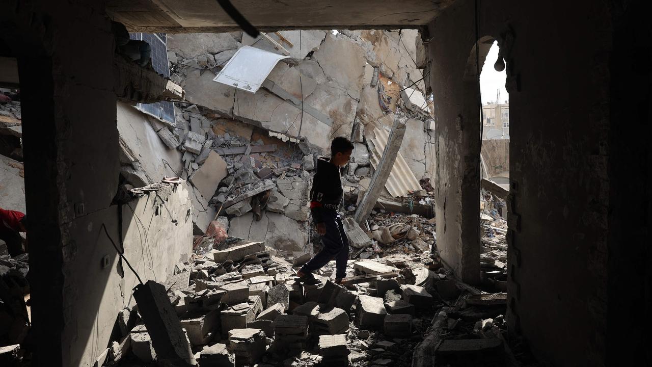 A Palestinian boy walks through the rubble following Israeli bombardment of Rafah's Tal al-Sultan district in the southern Gaza Strip on May 7, 2024. (Photo by AFP)