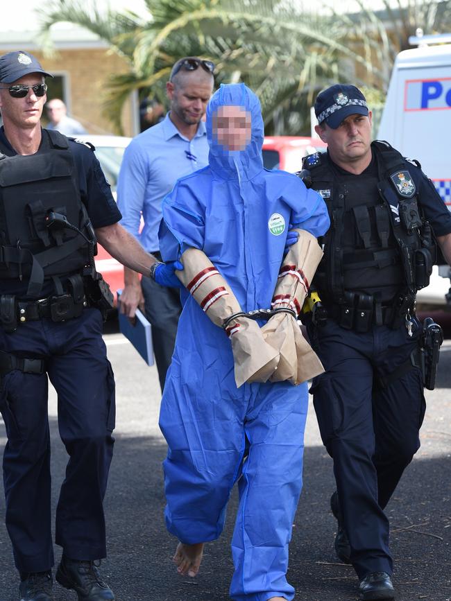 Police take a man into custody following the murder at a unit at 146 Cambridge St, Granville.