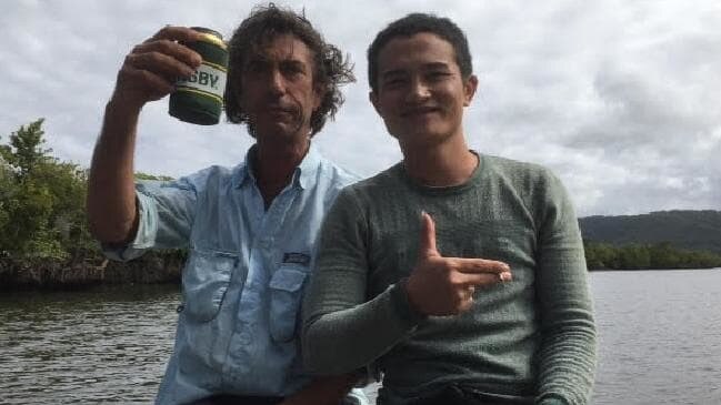 Justin Ward sharing a beer and a cigarette with an asylum seeker, believed to be from Vietnam, rescued from mangroves in the Daintree River.