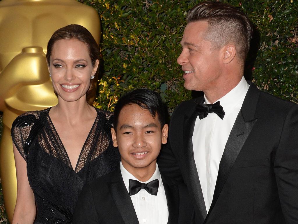 Angelina Jolie, Maddox Jolie-Pitt (C) and Brad Pitt in 2013.