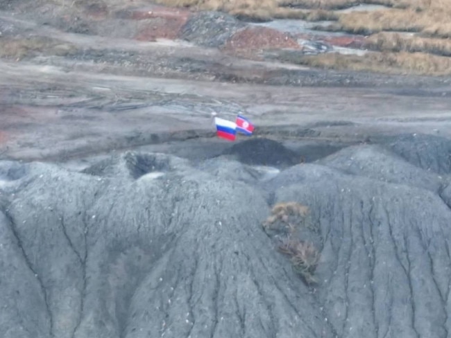 A photo shared on Telegram purports to show North Korea’s flag flying next to the Russian flag in Ukrainian territory. Picture: @milinfolive_man/TELEGRAM