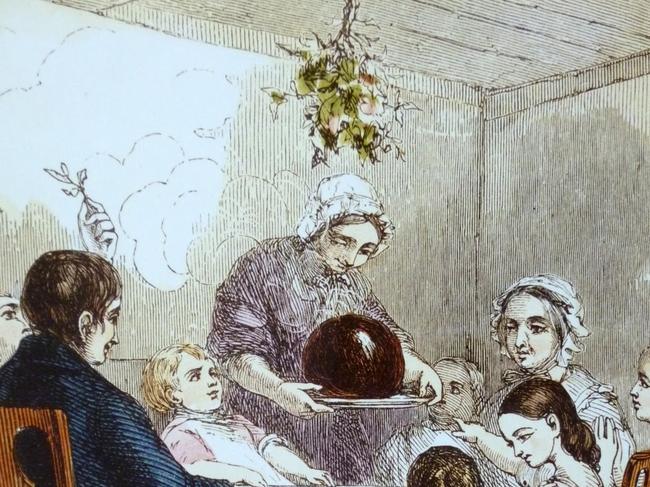 History: Presenting the plum pudding, a 19th century illustration of a Christmas feast. Out of copyright