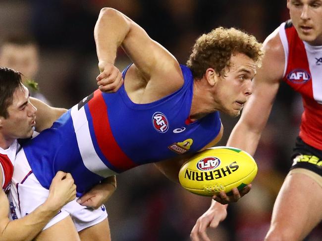 MELBOURNE, AUSTRALIA - AUGUST 04:  Mitch Wallis of the Bulldogs is tackled during the round 20 AFL match between the St Kilda Saints and the Western Bulldogs at Etihad Stadium on August 4, 2018 in Melbourne, Australia.  (Photo by Scott Barbour/Getty Images)