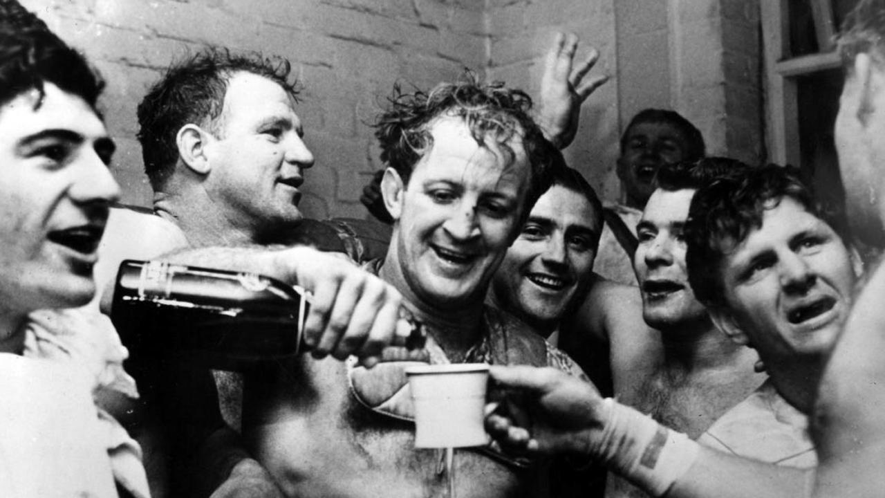 Johnny Raper pours champagne for his Kangaroos teammates after a win over Great Britain.