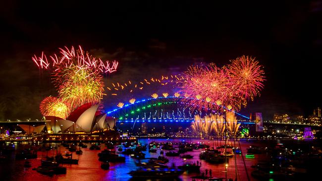 TOPSHOT - Fireworks explode over the Sydney Harbour Bridge and Sydney Opera House (L) during New Year's Eve celebrations in Sydney on January 1, 2024. (Photo by Izhar KHAN / AFP)