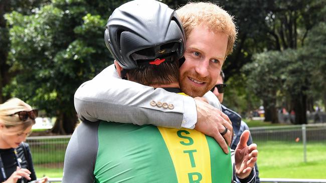 Prince Harry hugs Australian Invictus cyclist Michael Lyddiard. Picture: AAP Image/Brendan Esposito