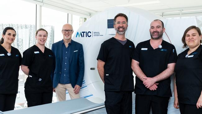 The MTIC team, described by Professor Rod Hicks as the best in the world, with the Quadra scanner. Picture: Martin Wood