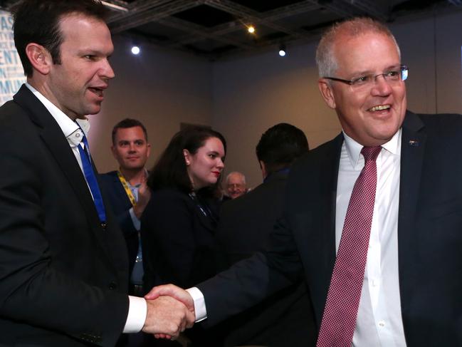 Prime Minister Scott Morrison (centre) shakes hands with Minister for Resources Matt Canavan as he arrives to speak at the LNP annual convention at the RNA convention centre, Brisbane, Saturday July 13, 2019. (AAP Image/Jono Searle) NO ARCHIVING