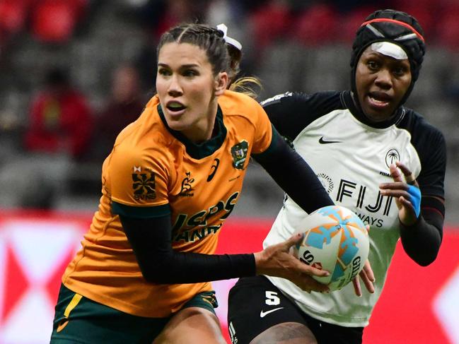 Australiaâs Charlotte Caslick controls the ball during the 2024 HSBC Canada Sevens rugby tournament match between Australia and Fiji at BC Place Stadium in Vancouver, Canada, on February 23, 2024. (Photo by Don MacKinnon / AFP)