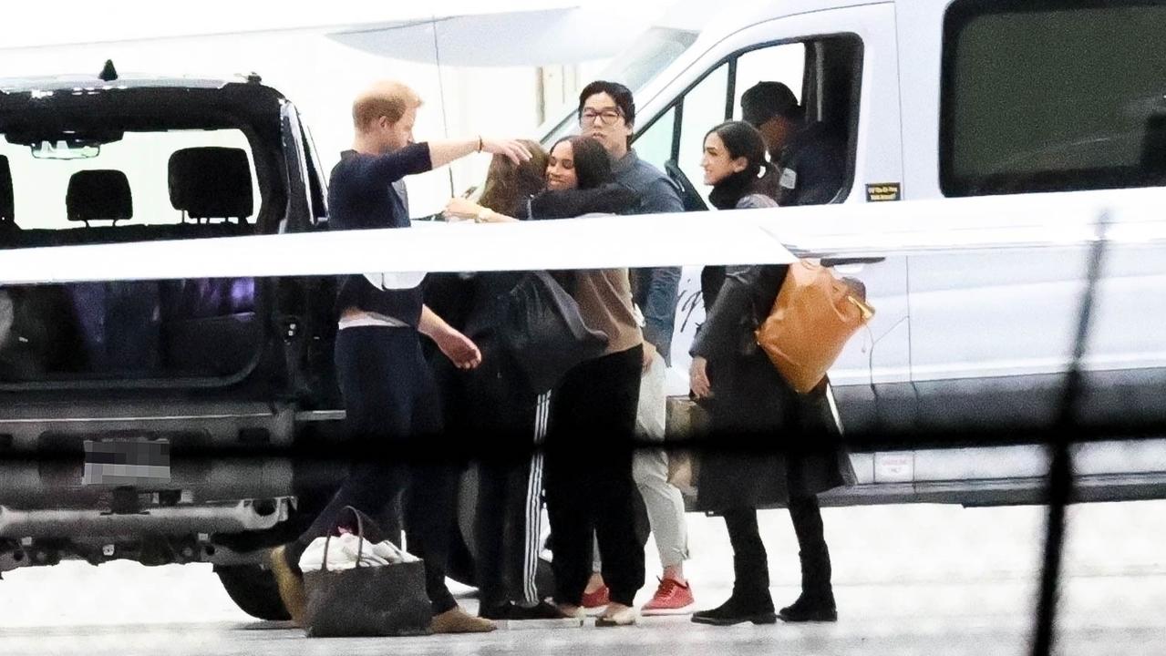 Harry and Meghan shown giving long hugs to people before heading home after a long trip to New York. Picture: Backgrid