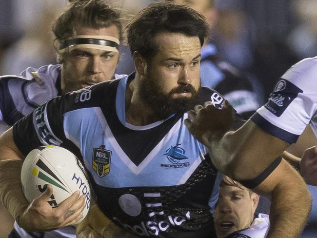 Aaron Woods of the Sharks is tackled during the Round 23 NRL match between the Cronulla-Sutherland Sharks and the North Queensland Cowboys at Southern Cross Group Stadium in Sydney, Saturday, August 18, 2018. (AAP Image/Craig Golding) NO ARCHIVING, EDITORIAL USE ONLY