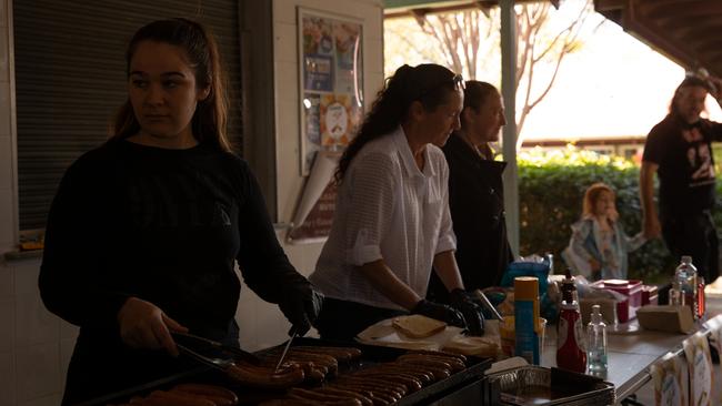 The St Georges Basin PNC lending a hand with the Sanctuary Point Public School sausage sizzle after their own hall was damaged by floods and the school was unable to host a polling booth. Picture: Nathan Schmidt