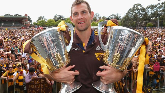 Luke Hodge with the 2013 and 2014 premiership cups.