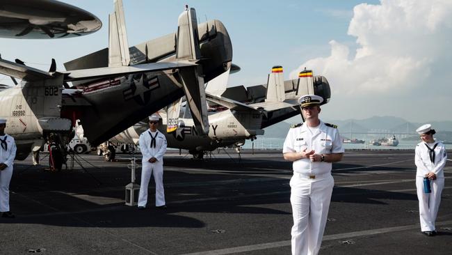 Members of the US Navy stand on board the USS Ronald Reagan in Hong Kong. Picture: Bloomberg.