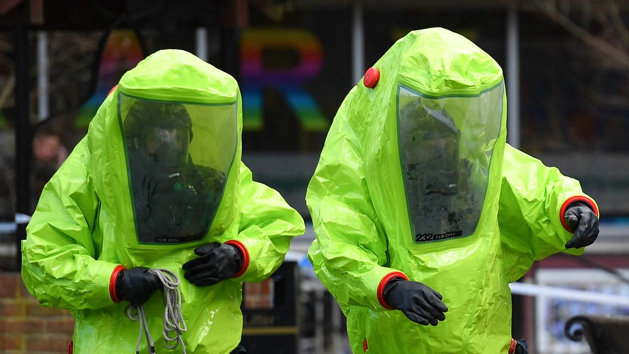 Emergency services workers in biohazard suits at the spot where a man and a woman were found on in critical condition after a Russian nerve agent attack on a former spy in 2018. Picture: Ben Stansall/AFP