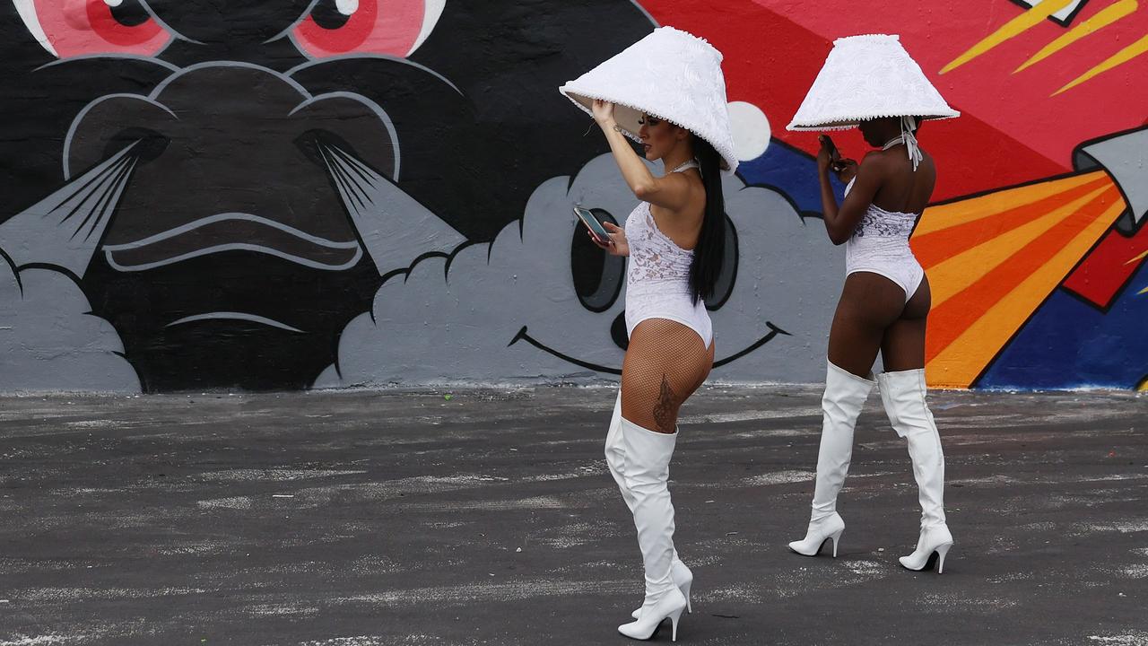 Catherine Lopes and Ebony Smith work to bring attention to the Nightclub E11even, which accepts cryptocurrency payment, at the Bitcoin 2021 Convention. Picture: Joe Raedle/Getty Images/AFP